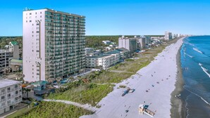 A coastal hotel with multiple floors, a beach view, and a lifeguard tower. - Luxurious 3-bedroom, 3-bathroom oceanfront condo, 7th floor views | Windy Hill Dunes - 703 (North Myrtle Beach)