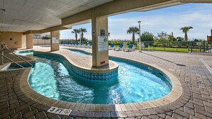 A pool area with a 3 FT no diving sign, lounge chairs, and a sign indicating pool hours. - Luxurious 3-bedroom, 3-bathroom oceanfront condo, 7th floor views | Windy Hill Dunes - 703 (North Myrtle Beach)