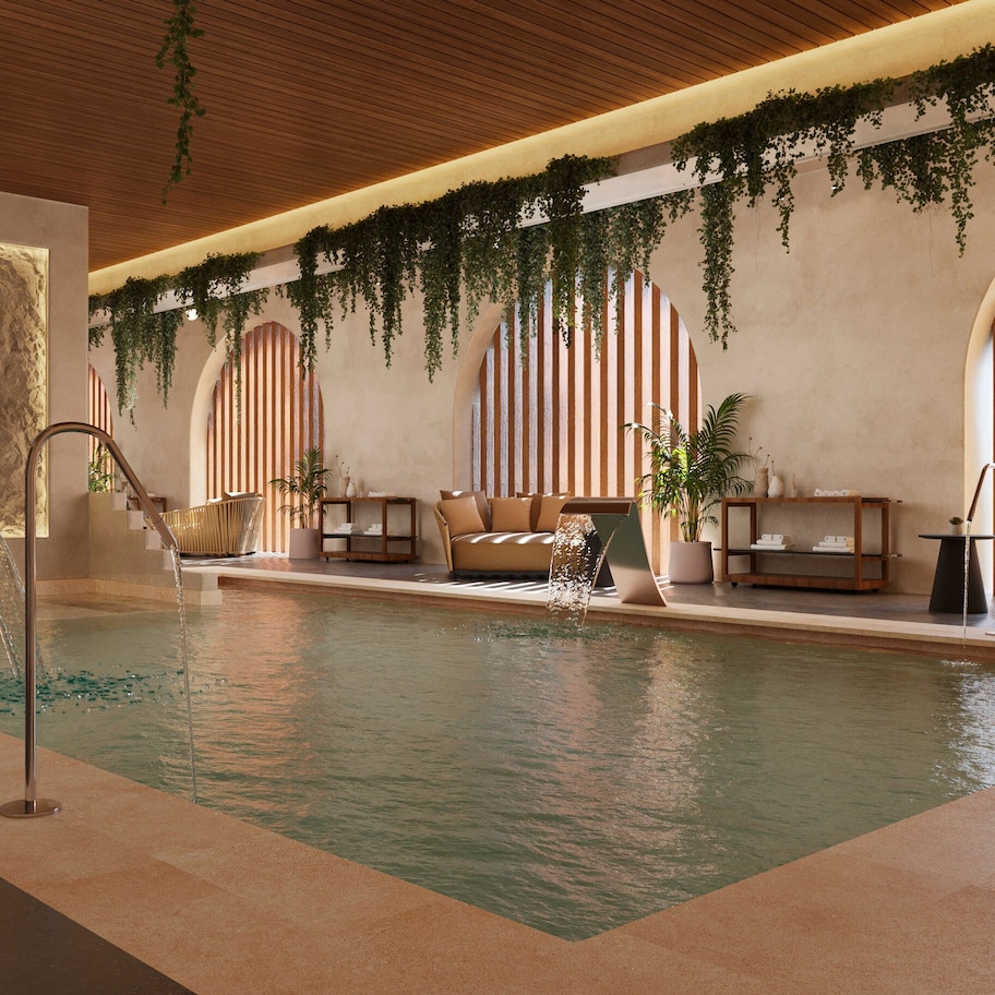 A pool area with a seating area, a reception desk, and a staircase.