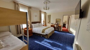 A hotel room with a bunk bed, a single bed, a desk with a chair, a mirror, and a television. - Botleigh Grange Hotel & Spa (Southampton)