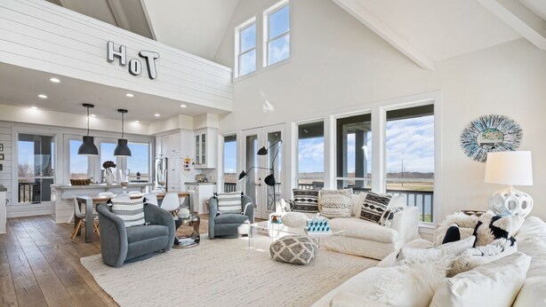 A spacious living area with a high ceiling, large windows, and a view of the outdoors. - #Beach Please - Amazing Views From All Directions - Close to the beach (Crystal Beach)
