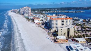 A coastal hotel with multiple buildings, a beach, and a marina. - Elevated Ground Level Direct Gulf Front 2 Bedroom/2 Bath Condo (Redington Shores)