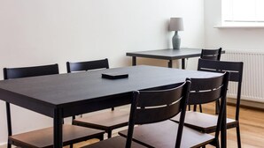 A dining area with a large rectangular table and six chairs.