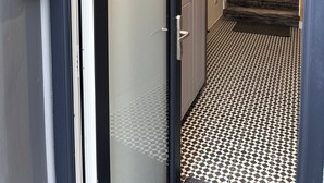 A hotel entrance with a door marked "No. 53," a staircase with a patterned carpet, and a security camera above the door. - 53 Luxury Rooms  (Maynooth)