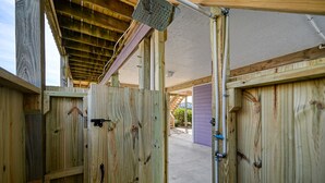 A wooden structure with a metal door, a concrete floor, and a wooden ceiling. - Ocean-View Retreat, Sleep 8, 6-Minute Walk to Restaurants, Pet friendly (Surf City)
