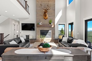 Relax in this stylish living room with a fireplace, flat-screen TV, and comfortable seating for two.
