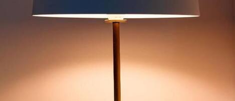 A table lamp with a wooden base and a dome-shaped lampshade.