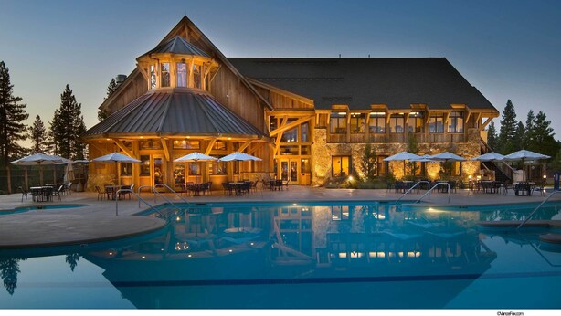 A large lodge with a swimming pool, outdoor seating, and a stone facade. - Old Greenwood Cabin 10 (Truckee)