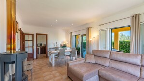 Una sala moderna con un sofá, un comedor y una chimenea.