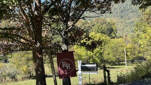 A mailbox with a sign reading "RR" and "1179" in a rural setting. - Peaceful Farmhouse w/ Fire Pit & Updated Comforts (Monroe)