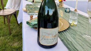 A bottle of champagne on a table with a tent overhead. - Peaceful Farmhouse w/ Fire Pit & Updated Comforts (Monroe)