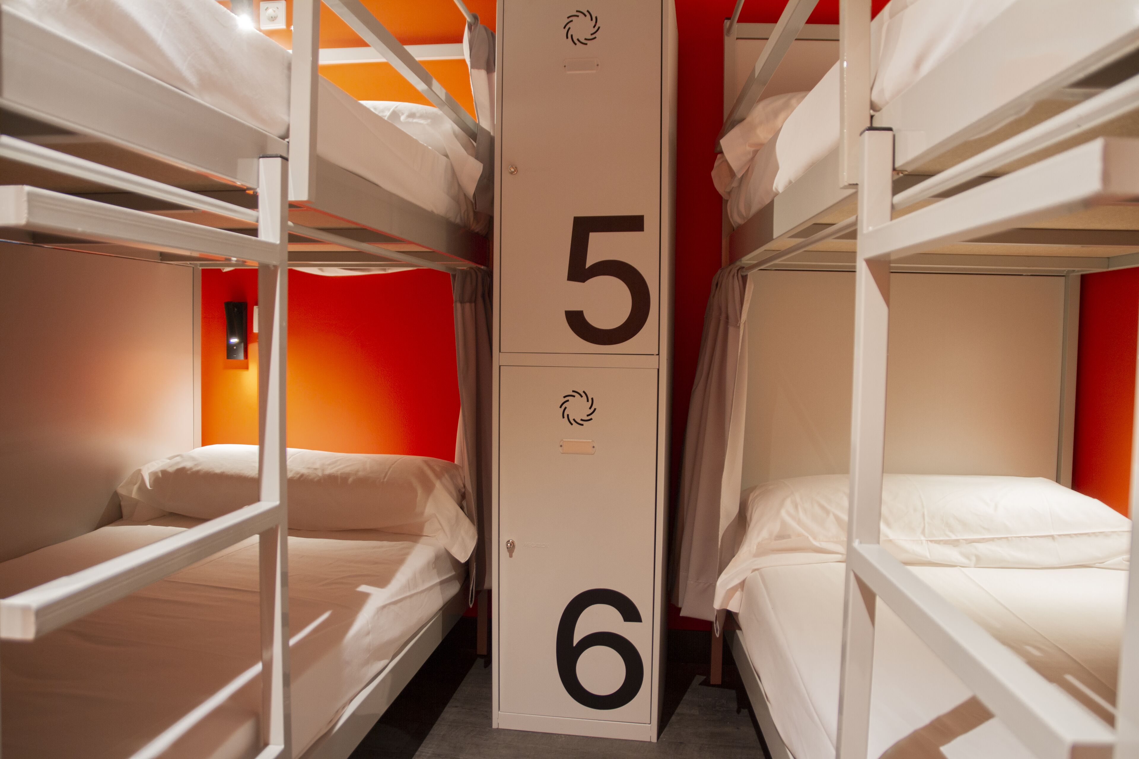A bunk bed room with numbers 5 and 6 on the wall, indicating room numbers.