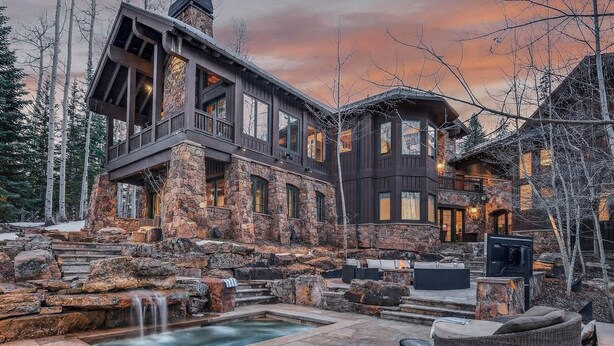 A multi-story stone building with a stone staircase leading to a pool, surrounded by trees. - Luxury Ski-in/out Estate Hot tub + Game Room Paragon (Avon)
