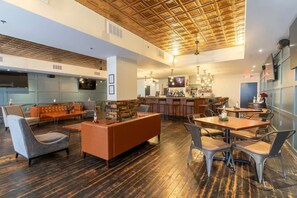 A spacious lounge area with a bar and seating arrangements.
