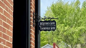A brick building with a sign indicating "McKittrick Suite" and "Vaultville Suite."