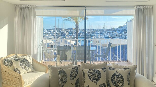 A balcony with a view of a marina and boats.