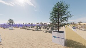 A beachside area with rows of sun loungers and umbrellas, a pathway, and a sign for 'agenzia marina'. - Master C in Bibione With 2 Bedrooms and 2 Bathrooms (San Michele al Tagliamento)