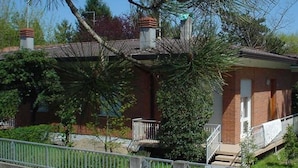A two-story brick building with a small porch and a staircase leading to the entrance. - Holiday 5 in Bibione (San Michele al Tagliamento)