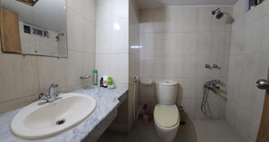 A bathroom with a sink, toilet, and shower. - Charming 3-bed Apartment in Mohammadpur Dhaka (Dhaka)