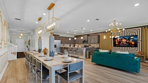 A modern kitchen with a central island, stainless steel appliances, and pendant lighting. - New Listing! Windsor Island, 10mi to Disney & 22mi to Universal - GRH813485 (Davenport)