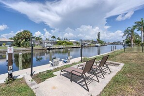 Enjoy serene waterfront views of a tranquil canal with a picturesque row of boats.