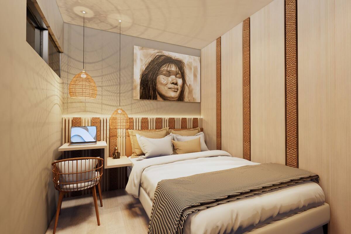 A modern bedroom with a bed, bedside table, lamp, and a wall-mounted picture.