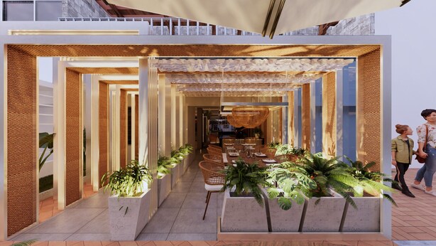 Un área de comedor exterior moderna con una larga mesa, sillas de mimbre y plantas en macetas.