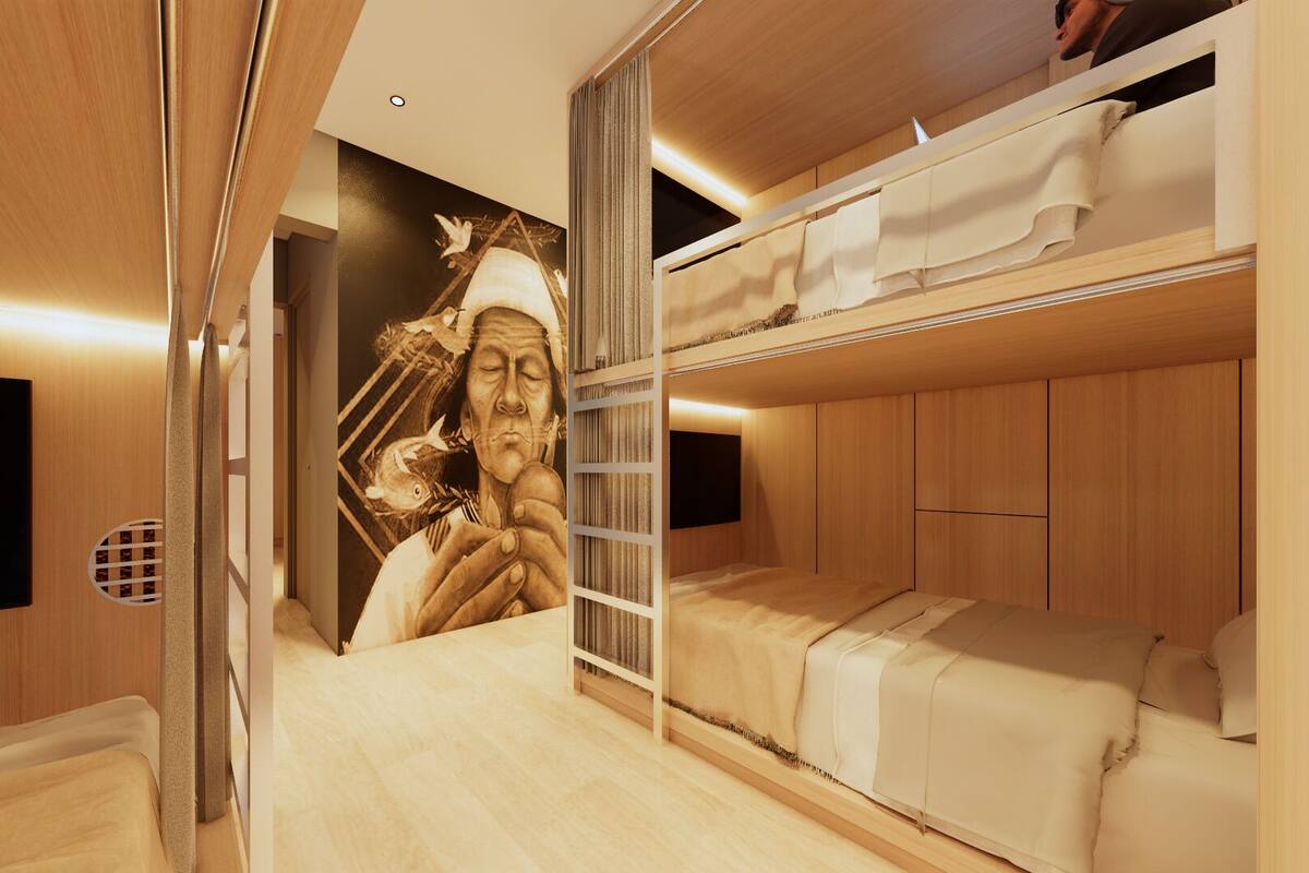 A bunk bed room with a mural on the wall, a flat-screen TV, and wooden paneling.
