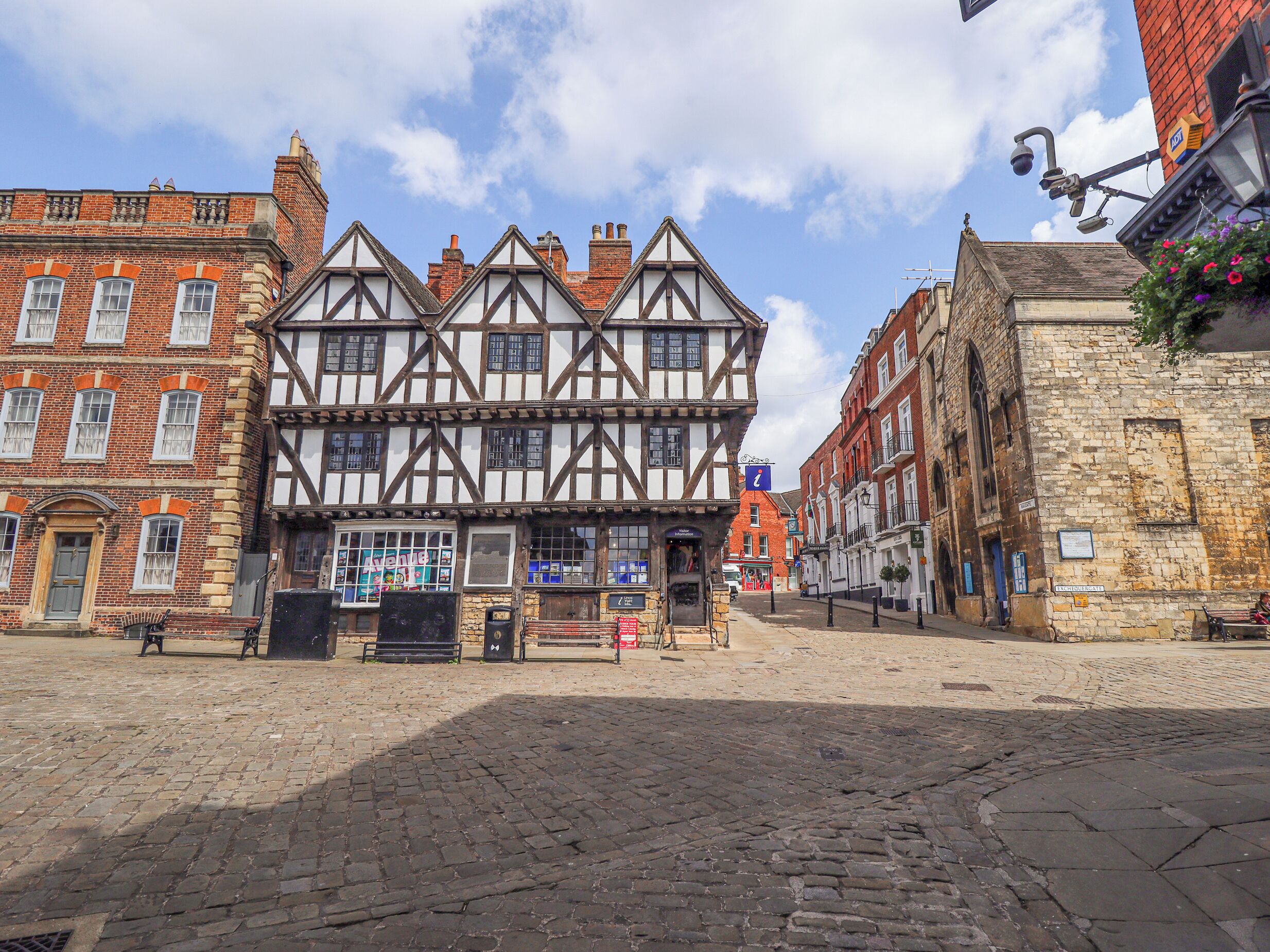 A traditional half-timbered building with a cobblestone street in front.