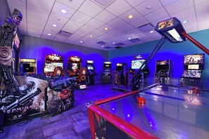 An arcade with multiple gaming machines, including a prominent Terminator-themed machine.