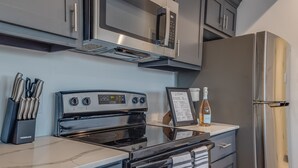 A modern kitchen with stainless steel appliances, including a stove, oven, microwave, and refrigerator. - 1 BR 1 BA Luxury - Museum District & Downtown HTX (Houston)