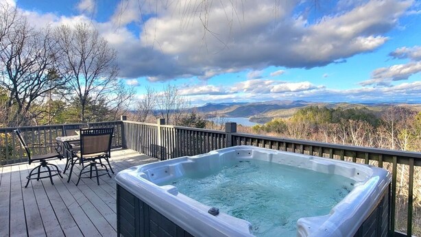 A hot tub on a deck with a view of mountains and a lake. - Lake View Cabin in ranger GA 4 Bedrooms (Ranger)