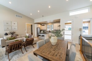 Enjoy meals and relaxation in this spacious living area with a large dining table and comfortable seating.