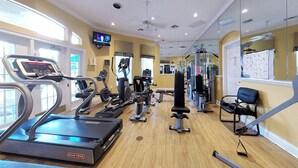 A gym with treadmills, elliptical machines, and weight equipment. - New Listing! Emerald Island Resort, 3mi to Disney & 13mi to Universal - GRH801523 (Kissimmee)