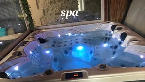 Ett bubbelbad med tillhörande kontrollpanel och en skylt med texten ”spa” i bakgrunden.
