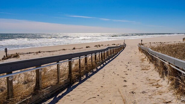 A beach path leading to the ocean with a wooden fence on one side and a metal railing on the other. - Oceanfront Escape Just Steps to Beach & Boardwalk , beach badges 2 car park (Seaside Heights)