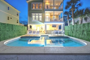 A two-story building with a swimming pool, outdoor seating, and a well-maintained hedge. - 6 bedroom Oasis - Pool (St. Augustine)