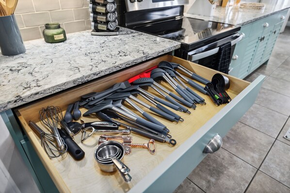 A kitchen drawer with various utensils and kitchen tools. - 6 bedroom Oasis - Pool (St. Augustine)