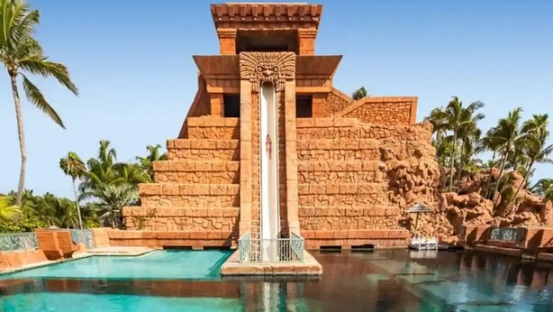 A clear pool with a central water slide and sharks swimming. - COMPLIMENTARY CAR! CASA DEL MAR! (Nassau)