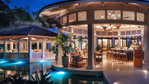 A circular outdoor lounge area with seating and a pool, surrounded by a covered patio. - COMPLIMENTARY CAR! CASA DEL MAR! (Nassau)