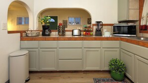 A kitchen with a microwave, coffee maker, and various kitchen items on the counter. - Stylish 2B2B Hideaway 10 mins. drive to Disneyland (Santa Ana)