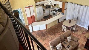 A compact living space with a kitchenette, a dining area, and a sofa. - Spacious Pool House....completely Private!! (Lakeland)