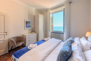 A hotel room with a bed, a chair, a dresser, a window with a view, and a radiator. - 🏠 PROPERTY DESCRIPTIONCasa Valentina is located in a typical Ligurian building, in a central area near the charming harbor of Camogli.It is the perfect starting point for a seaside holiday without the need to use a car or public transport.In just 5 mi (Camogli)