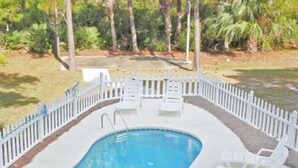 A rectangular swimming pool with a white deck and a white picket fence surrounding it. - 4C & Sand • Private Pool • Steps to Beach (St. George Island)
