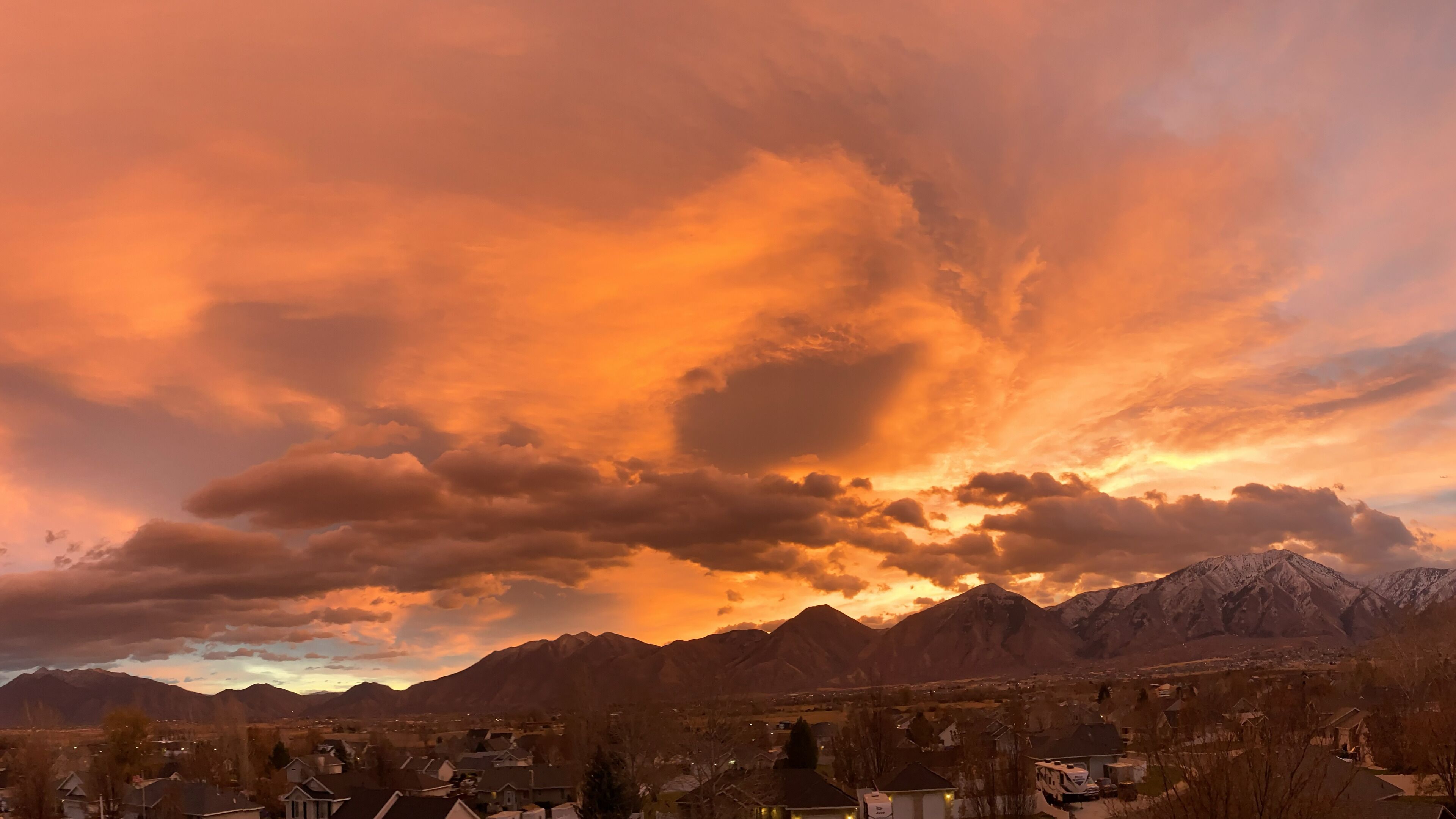 A mountain range with a town in the foreground.