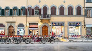 A street with closed shops, a wooden door, and a bicycle rack.