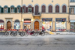 A street with closed shops, a wooden door, and a bicycle rack.