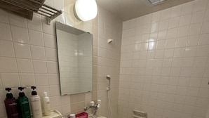 A bathroom with a toilet, sink, and bathtub. There are toiletries on the sink counter. - HOTEL FLOR (Utsunomiya)