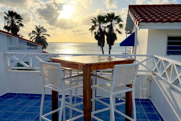 Upper deck with table for 4 overlooking the Caribbean Sea