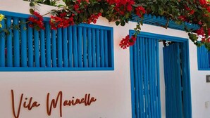 A white building with blue shutters and a sign that reads "Vila Marinha". - Vila Marinella (Jijoca de Jericoacoara)